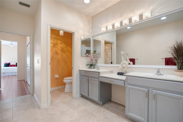 bathroom with vanity, toilet, and tile patterned flooring