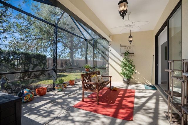 sunroom / solarium featuring ceiling fan