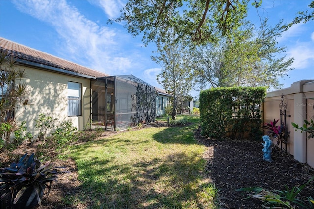 view of yard featuring glass enclosure