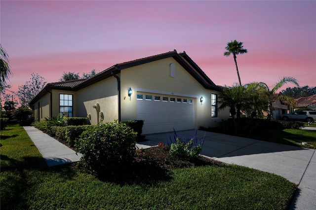 view of front facade with a garage and a yard