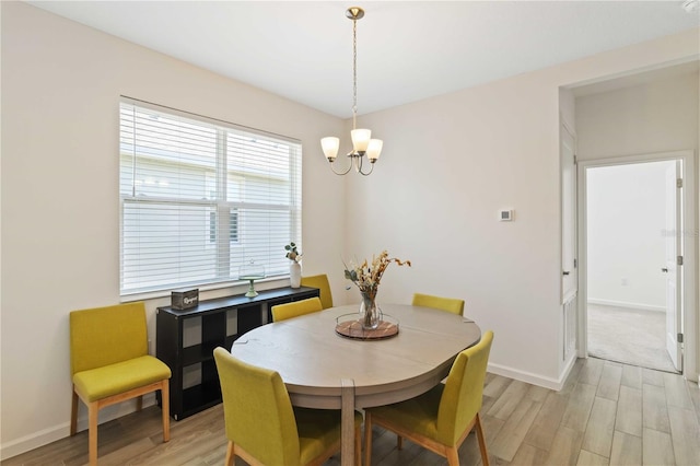 dining room with a notable chandelier and light hardwood / wood-style floors