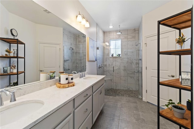 bathroom with vanity and a shower with door