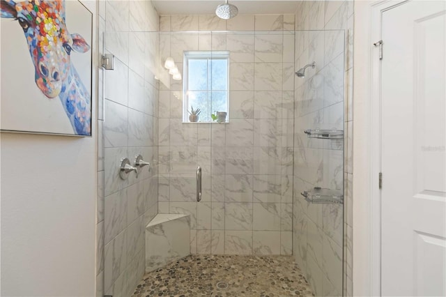 bathroom with a shower with door