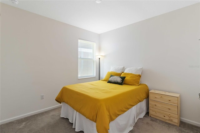 bedroom with dark colored carpet