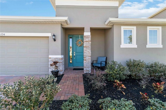 view of exterior entry with a garage