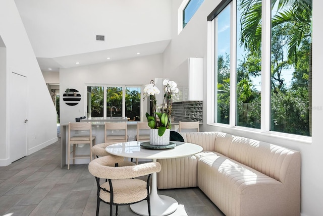 sunroom / solarium featuring sink and breakfast area