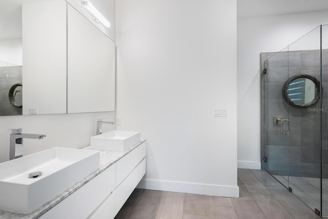 bathroom with vanity and a shower with shower door