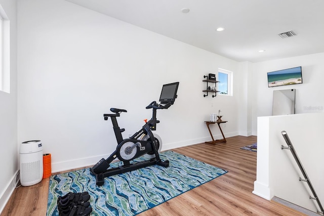 exercise room with wood-type flooring