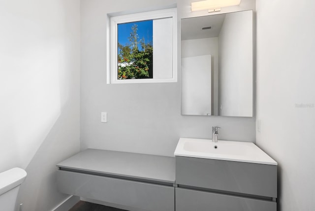 bathroom featuring vanity and toilet