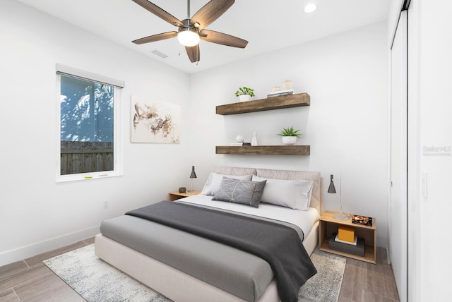 bedroom featuring hardwood / wood-style floors and ceiling fan