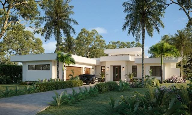 view of front of property with a garage and a front yard