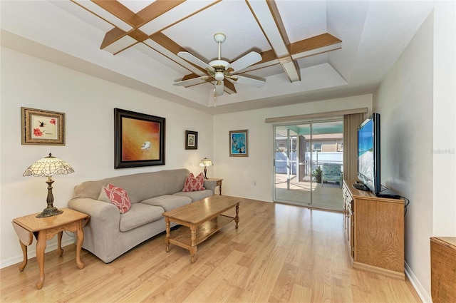 living room with ceiling fan, coffered ceiling, and light hardwood / wood-style floors