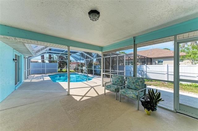 view of pool featuring a lanai and a patio