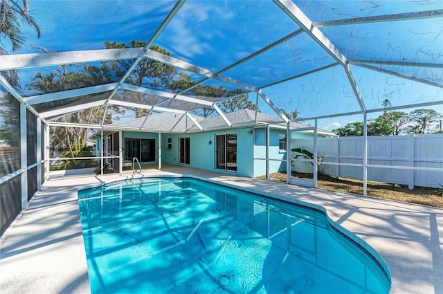 view of pool featuring a patio area and glass enclosure