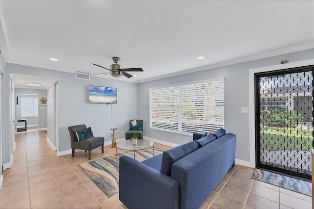 tiled living room featuring ornamental molding and ceiling fan