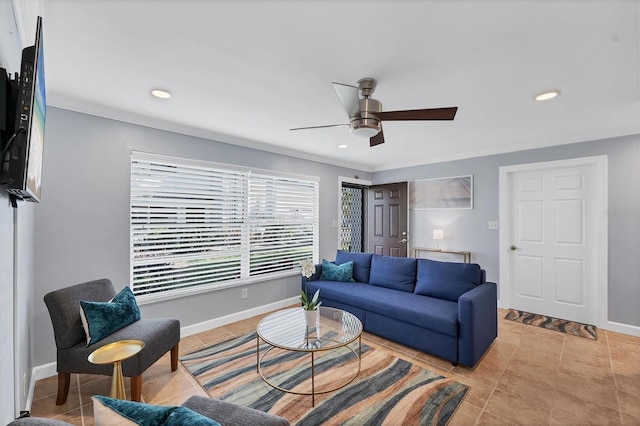 living room featuring ornamental molding, light tile patterned floors, and ceiling fan