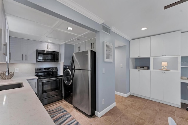 kitchen with coffered ceiling, sink, white cabinetry, ornamental molding, and stainless steel appliances