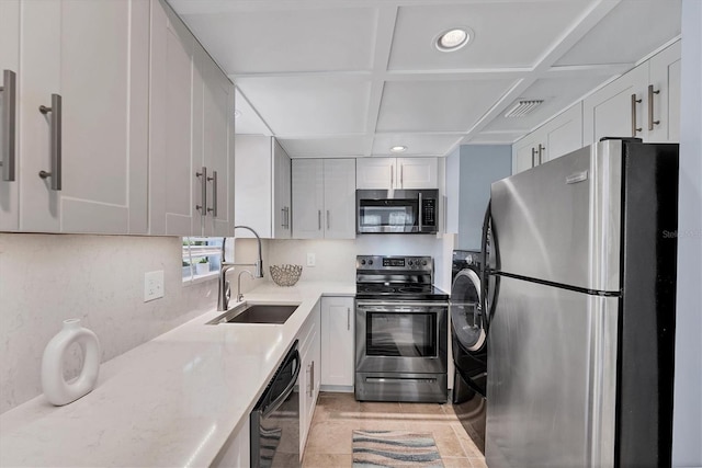 kitchen with white cabinetry, appliances with stainless steel finishes, coffered ceiling, and sink