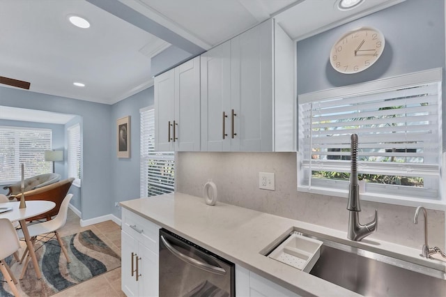 kitchen with white cabinetry, a healthy amount of sunlight, stainless steel dishwasher, and light tile patterned floors