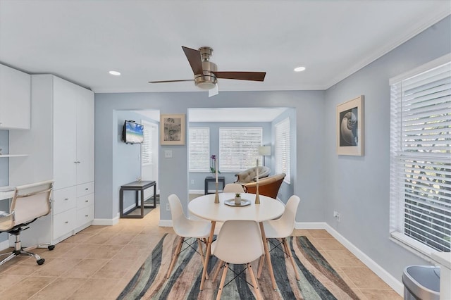 dining space with light tile patterned floors, crown molding, and ceiling fan