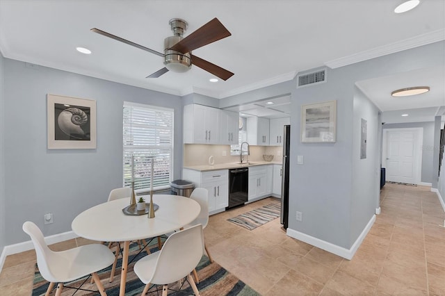 tiled dining room featuring ceiling fan, ornamental molding, and sink