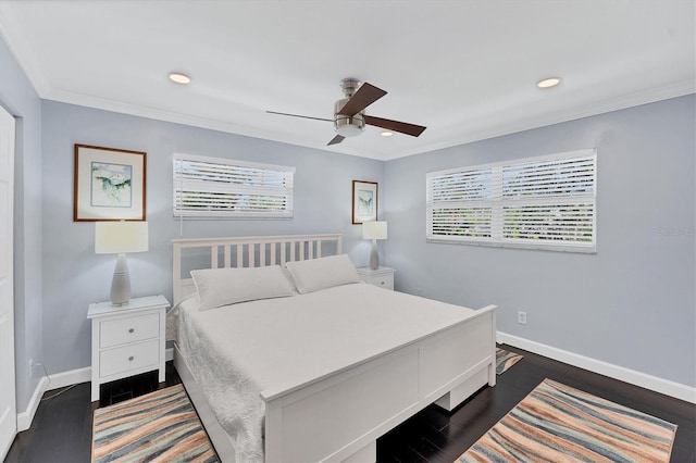 bedroom with dark hardwood / wood-style floors and multiple windows