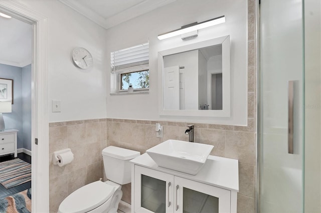 bathroom featuring ornamental molding, tile walls, vanity, and toilet