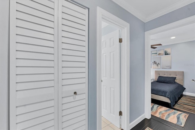 corridor with ornamental molding and wood-type flooring