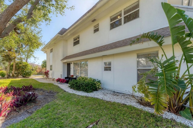 view of side of home with a lawn