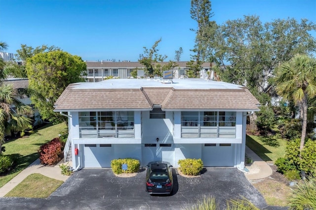 view of front of house featuring a garage and a balcony