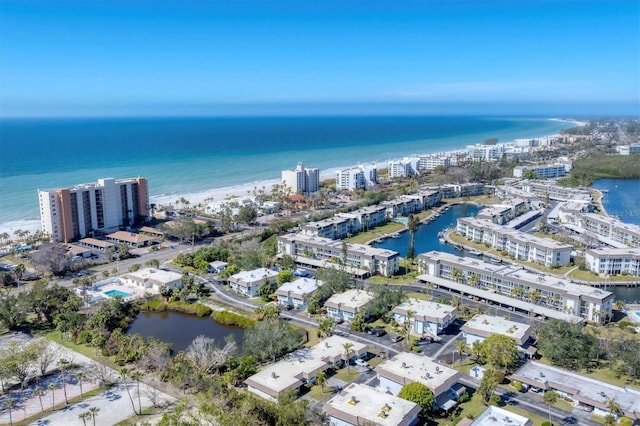 drone / aerial view featuring a beach view and a water view