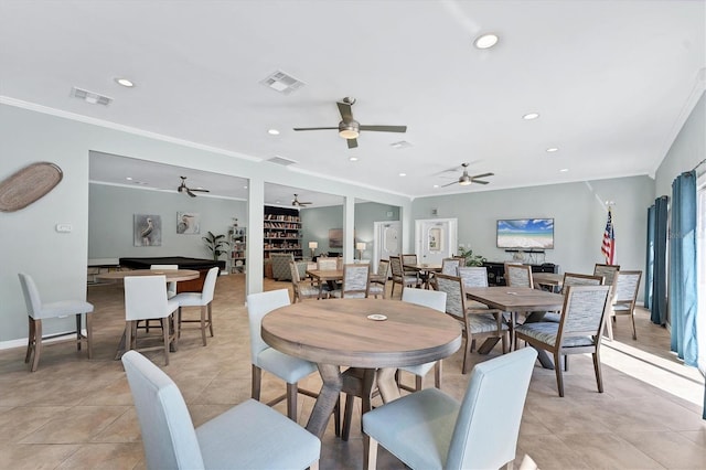 dining area with light tile patterned floors and crown molding