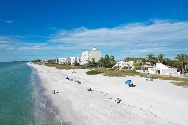 aerial view with a water view and a beach view