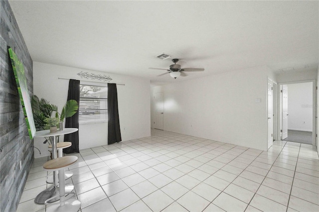 empty room featuring light tile patterned floors and ceiling fan