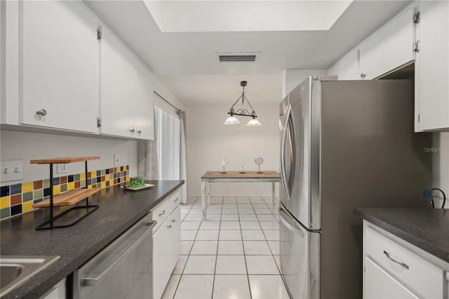 kitchen with tasteful backsplash, pendant lighting, stainless steel appliances, and white cabinets