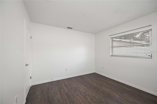 empty room featuring dark hardwood / wood-style floors