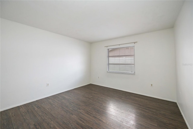 unfurnished room featuring dark wood-type flooring