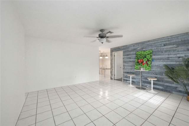 tiled spare room featuring ceiling fan