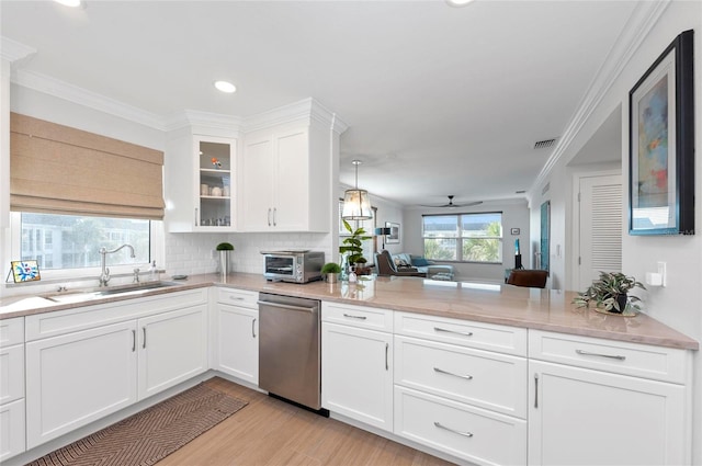 kitchen with light hardwood / wood-style flooring, sink, dishwasher, white cabinets, and crown molding