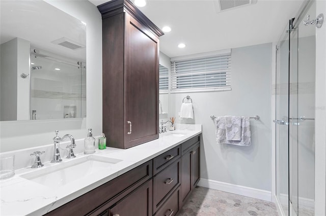 bathroom featuring vanity and a shower with shower door