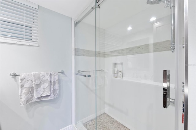 bathroom with a shower with door