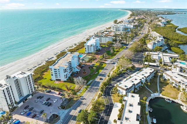 bird's eye view featuring a view of the beach and a water view