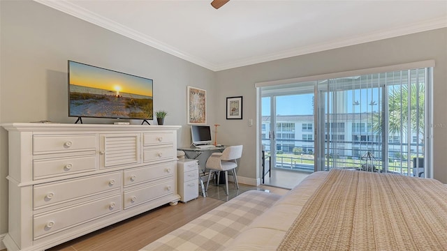 bedroom with multiple windows, wood finished floors, baseboards, and ornamental molding