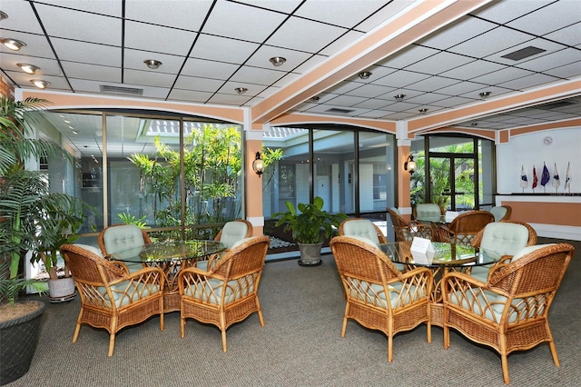 sunroom with carpet floors, visible vents, and a paneled ceiling