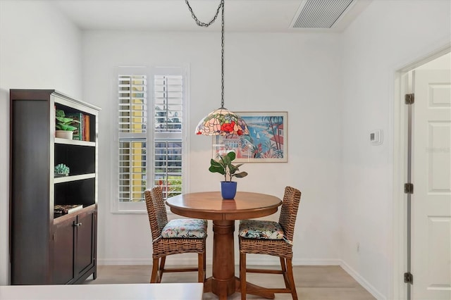 dining space featuring light hardwood / wood-style flooring and a healthy amount of sunlight