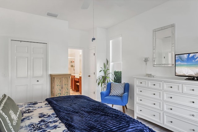 bedroom featuring connected bathroom and a closet