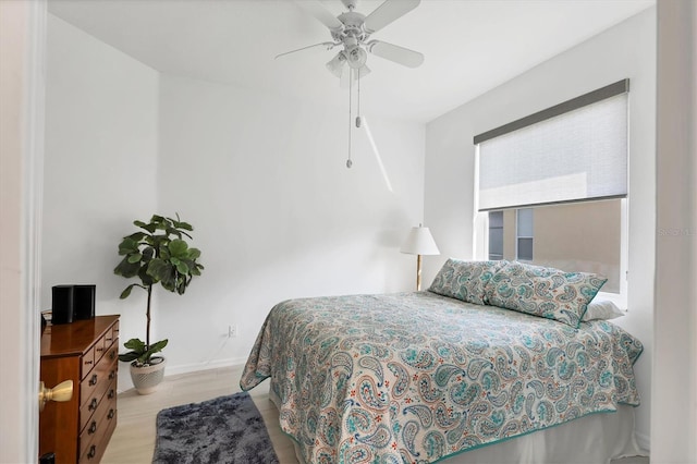 bedroom with light hardwood / wood-style flooring and ceiling fan