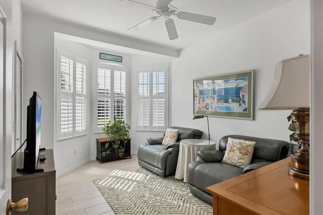 sitting room with ceiling fan and light hardwood / wood-style flooring