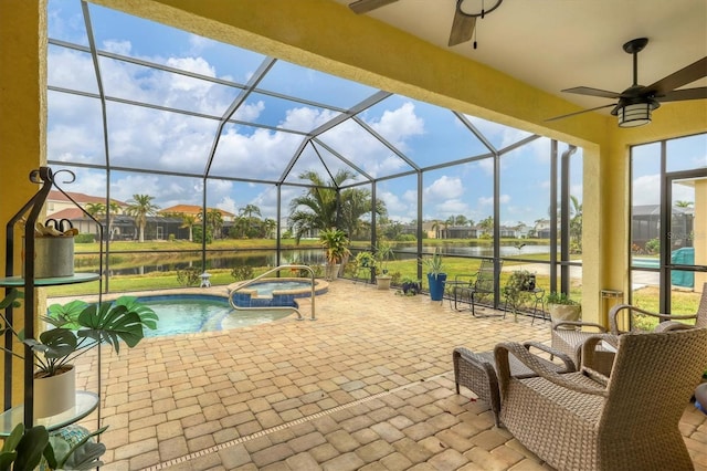 view of pool with a water view, an in ground hot tub, a lanai, and a patio area