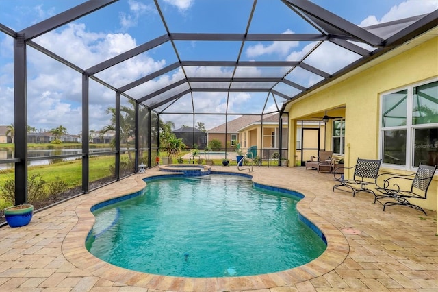 view of swimming pool featuring an in ground hot tub, a water view, a lanai, and a patio area